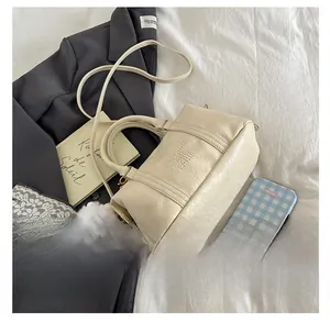 Macro detail of creamy beige pebble leather bag with Fashion Air Paris embossed logo
