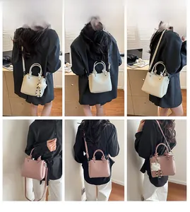 Model display of stylish lychee texture crossbody bags with plush ball charms and handles