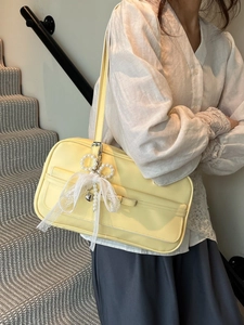 Elegant pale yellow shoulder bag for women with lace bow and pearl heart charm accessory