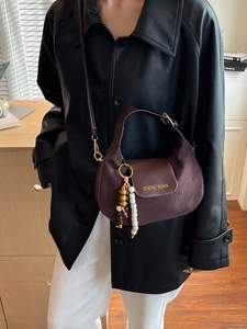 Minimalist dark brown suede crossbody bag with vintage beads and brand lettering