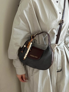 Chic dark gray suede hobo bag with brown leather flap and retro wooden bead pendant