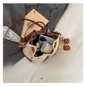 Top view of bucket bag interior capacity showing storage for phone and cosmetics