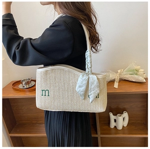 Beige woven tote bag featuring floral scarf detail and embroidered M on shoulder strap