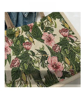 Detail of floral tote bag made of textured linen fabric with vibrant pink hibiscus print
