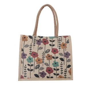 Linen tote bag with colorful floral print and brown woven handles for women