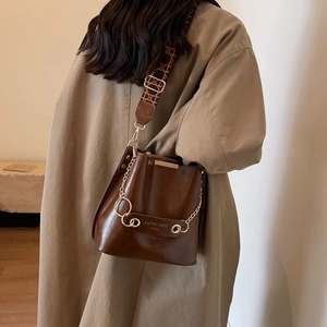 Retro dark brown leather bucket bag with jacquard strap and gold chain detail