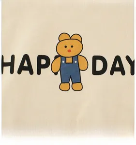 Detail of cute cartoon bear print and HAP DAY text on beige cotton kids t-shirt