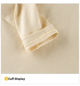 Detail view of the ribbed cuff stitching on this cream long-sleeve cotton toddler t-shirt
