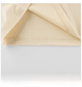 Detailed close-up of neat hem stitching on a beige long-sleeve cotton T-shirt for girls