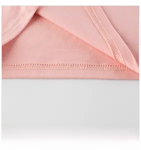 Detailed close-up showing the smooth stitching and soft pink knit fabric on children's T-shirt
