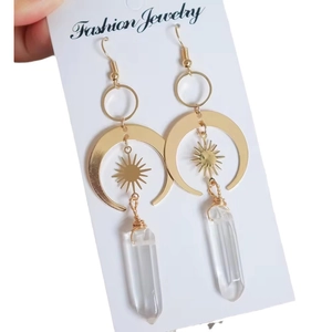 Bohemian gold sun and moon earrings with clear crystal prism pendants on display