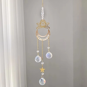 Detail of golden moon and lotus suncatcher with crystal ball pendants for home decor