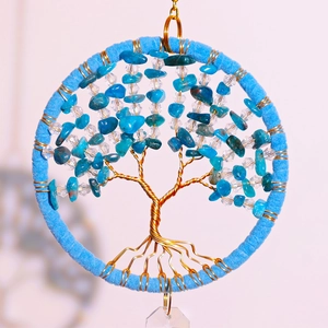 Detailed macro view of crystal tree of life car charm with blue stones and gold wire