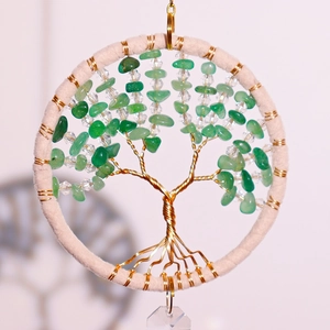 Detail of tree of life suncatcher with green crystal stones and clear crystal pendant