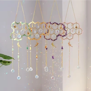 Golden honeycomb suncatcher with colorful natural crystals and hanging prisms