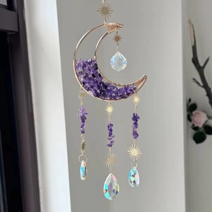 Detailed shot of crescent moon suncatcher with purple crystal and rainbow prisms