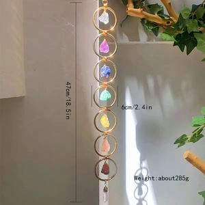 Detailed view of handmade 7 chakra raw stone wall hanging with gold metal rings