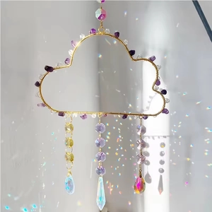 Detail of cloud-shaped suncatcher with colorful crystal beads and rainbow prism reflections