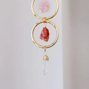 Handmade wall hanging with crystal stones, rose quartz and clear quartz point on gold rings