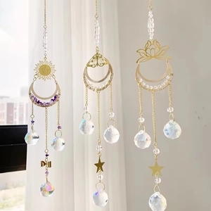 Three-piece gold crystal suncatcher set with lotus, moon, and butterfly pendant charms