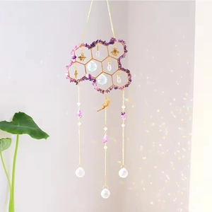 Cloud crystal suncatcher with golden honeycomb and purple stones creating rainbow light