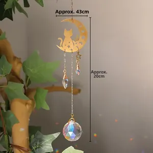 Detail showing a golden moon and cat crystal suncatcher, measures approx. 4.3x20cm
