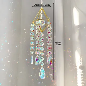 Detailed view of golden sun catcher with dimensions 8x33cm and faceted crystal teardrop