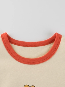 Girls long sleeve cotton T-shirt featuring contrast orange crew neck and cartoon design