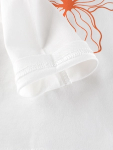 White cotton long-sleeve toddler t-shirt with orange floral print and neat cuff stitching