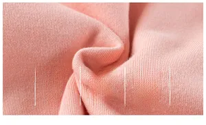 Close-up of soft pink breathable cotton fabric with tight knitted texture detail