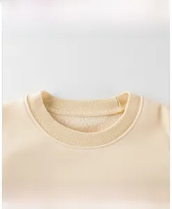 Detail of warm beige sweatshirt neckline featuring premium ribbed collar and fleece lining