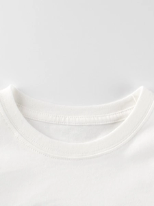 Close-up of white round neck cotton t-shirt for kids showing premium ribbed collar detail