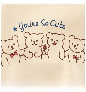 Detail of cute cartoon bear print with flowers and stars on beige cotton sweatshirt