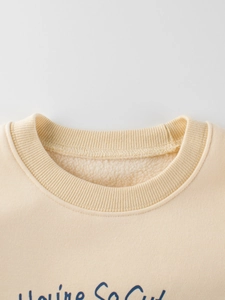 Kids cream sweatshirt with blue You're So Cut print and warm fleece lining details