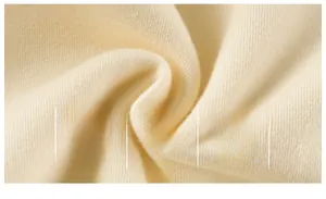 Macro shot of soft beige cotton knit fabric showing premium texture and A-level quality