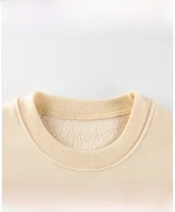 Detailed close-up of the ribbed crew neck and soft fleece lining of the kid's sweatshirt