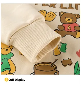 Close-up of ribbed cuffs on a cream toddler sweatshirt with cute bear and floral prints