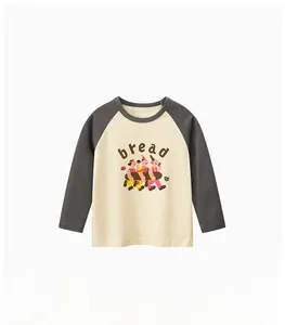 Detail of kids long sleeve raglan shirt with cartoon bread print on cotton fabric