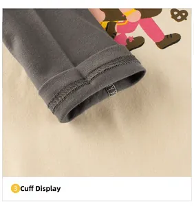 Close-up of ribbed cuffs and fine stitching on a cotton cartoon long sleeve T-shirt
