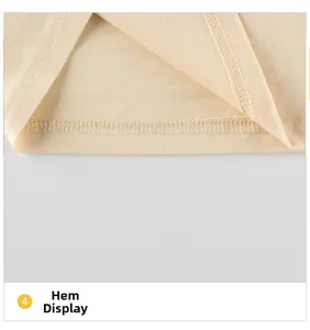 Detailed macro view showing high-quality double-needle hem stitching on beige kids t-shirt
