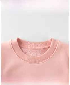 Detail of pink sweatshirt ribbed neckline with soft fleece lining and red lettering print