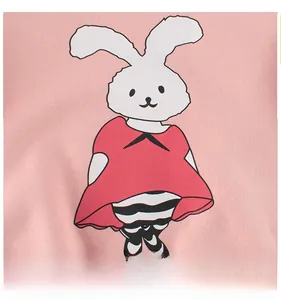 Detailed close-up of a cute cartoon white rabbit patch on a pink cotton sweatshirt