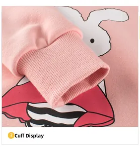 Close-up of pink cotton sweatshirt cuff with ribbed detail and white rabbit print