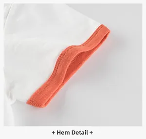 Detailed close-up of white cotton T-shirt hem with contrast orange ribbed trim stitching