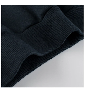 Close-up of deep blue ribbed knit cuffs and hem texture on children sweatshirt