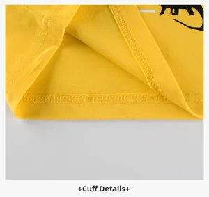 Detailed macro view of yellow ribbed cuffs and stitching on kids dinosaur shirt