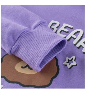 Close-up of purple ribbed cuffs and cute bear print on children's fleece sweatshirt