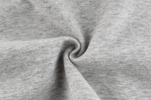 Close-up detail of soft grey heather knit fabric showing texture on children sweatshirt