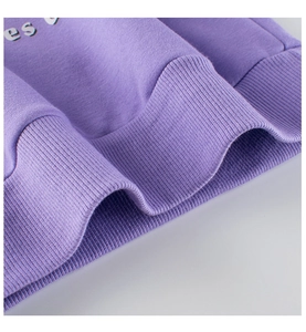 Detail of taro purple sweatshirt rib hem with soft knit fabric and letter printing