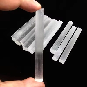 Natural white selenite crystal wands with fibrous texture for meditation on black background